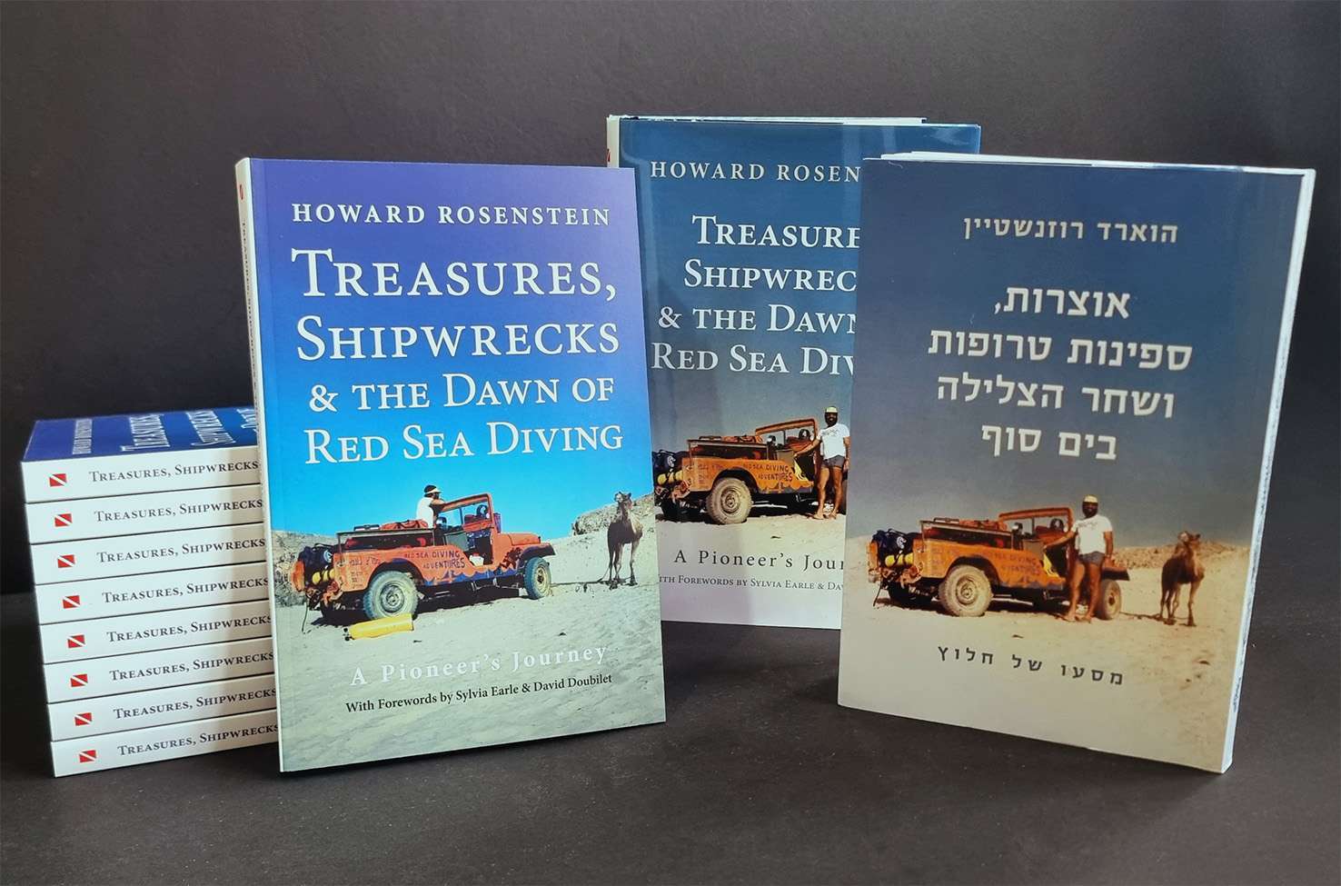 The paperback, hardback and Hebrew editions of Treasures, Shipwrecks and the Dawn of Red Sea Diving